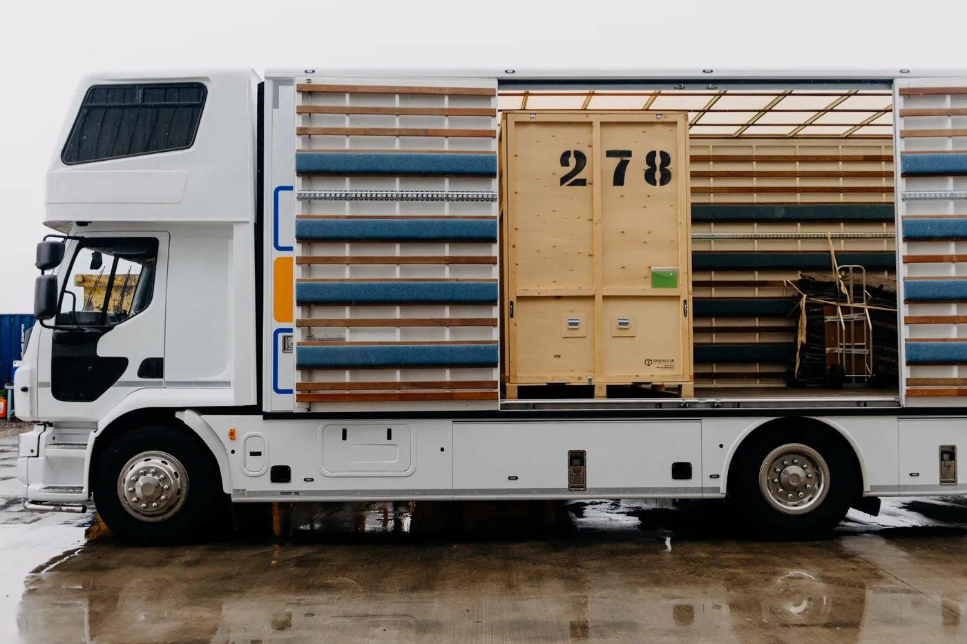 Removal lorry loaded with timber storage containers